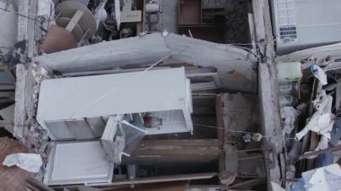 This stock vertical video shows the aftermath of the war in Ukraine - a destroyed residential building in Borodyanka, grey, flat video