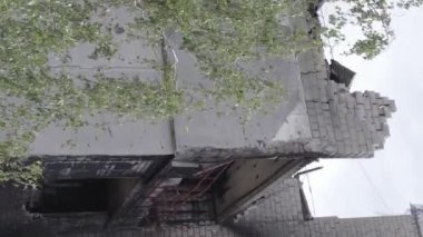 This stock vertical video shows the aftermath of the war in Ukraine - a destroyed residential building in Borodyanka, grey, flat video