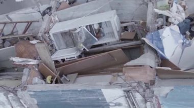 This stock vertical video shows the aftermath of the war in Ukraine - a destroyed residential building in Borodyanka, grey, flat video