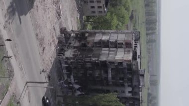 This stock vertical video shows the aftermath of the war in Ukraine - a destroyed residential building in Borodyanka, grey, flat video