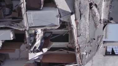 This stock vertical video shows the aftermath of the war in Ukraine - a destroyed residential building in Borodyanka, grey, flat video