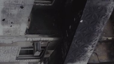 This stock vertical video shows the aftermath of the war in Ukraine - a destroyed residential building in Borodyanka, grey, flat video