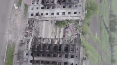 This stock vertical video shows the aftermath of the war in Ukraine - a destroyed residential building in Borodyanka, grey, flat video