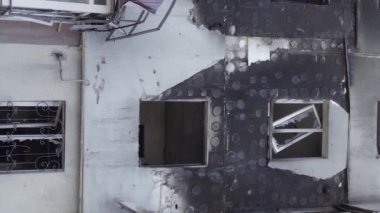 This stock vertical video shows the aftermath of the war in Ukraine - a destroyed residential building in Borodyanka, grey, flat video