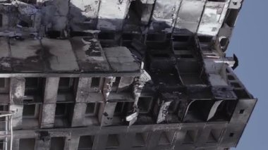 This stock vertical video shows the aftermath of the war in Ukraine - a destroyed residential building in Borodyanka, grey, flat video