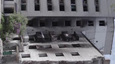 This stock vertical video shows the aftermath of the war in Ukraine - a destroyed residential building in Borodyanka, grey, flat video