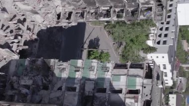 This stock vertical video shows the aftermath of the war in Ukraine - a destroyed residential building in Borodyanka, grey, flat video