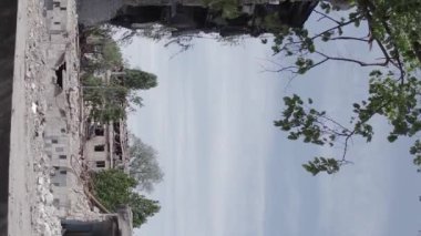 This stock vertical video shows the aftermath of the war in Ukraine - a destroyed residential building in Borodyanka, grey, flat video