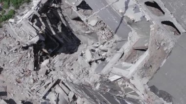 This stock vertical video shows the aftermath of the war in Ukraine - a destroyed residential building in Borodyanka, grey, flat video