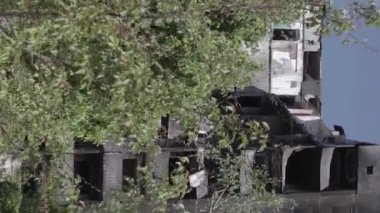 This stock vertical video shows the aftermath of the war in Ukraine - a destroyed residential building in Borodyanka, grey, flat video