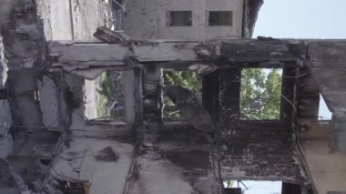This stock vertical video shows the aftermath of the war in Ukraine - a destroyed residential building in Borodyanka, grey, flat video