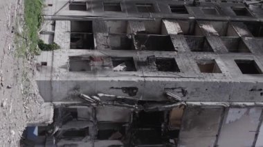 This stock vertical video shows the aftermath of the war in Ukraine - a destroyed residential building in Borodyanka, grey, flat video
