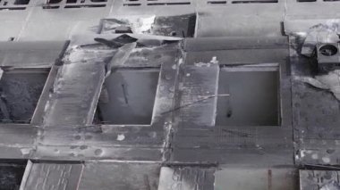 This stock vertical video shows the aftermath of the war in Ukraine - a destroyed residential building in Borodyanka, grey, flat video
