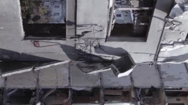 This stock vertical video shows the aftermath of the war in Ukraine - a destroyed residential building in Borodyanka, grey, flat video