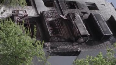 This stock vertical video shows the aftermath of the war in Ukraine - a destroyed residential building in Borodyanka, grey, flat video
