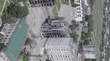 This stock vertical video shows the aftermath of the war in Ukraine - a destroyed residential building in Borodyanka, grey, flat video