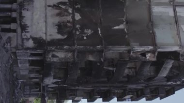 This stock vertical video shows the aftermath of the war in Ukraine - a destroyed residential building in Borodyanka, grey, flat video