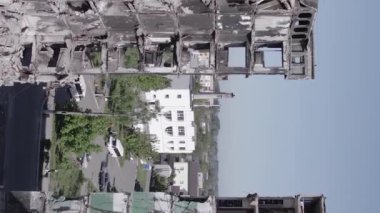 This stock vertical video shows the aftermath of the war in Ukraine - a destroyed residential building in Borodyanka, grey, flat video