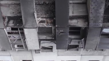 This stock vertical video shows the aftermath of the war in Ukraine - a destroyed residential building in Borodyanka, grey, flat video