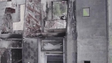 This stock vertical video shows the aftermath of the war in Ukraine - a destroyed residential building in Borodyanka, grey, flat video