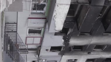 This stock vertical video shows the aftermath of the war in Ukraine - a destroyed residential building in Borodyanka, grey, flat video