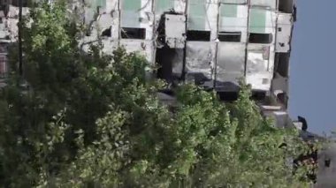 This stock vertical video shows the aftermath of the war in Ukraine - a destroyed residential building in Borodyanka, grey, flat video