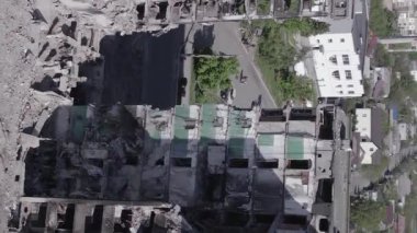 This stock vertical video shows the aftermath of the war in Ukraine - a destroyed residential building in Borodyanka, grey, flat video