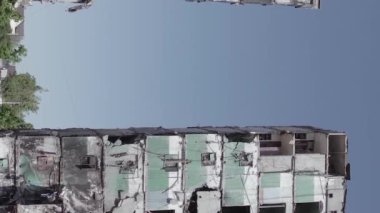 This stock vertical video shows the aftermath of the war in Ukraine - a destroyed residential building in Borodyanka, grey, flat video