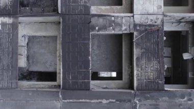 This stock vertical video shows the aftermath of the war in Ukraine - a destroyed residential building in Borodyanka, grey, flat video