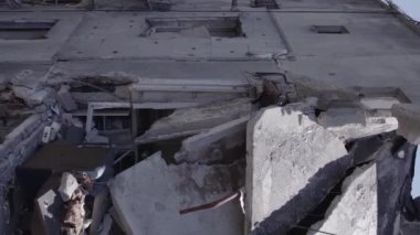 This stock vertical video shows the aftermath of the war in Ukraine - a destroyed residential building in Borodyanka, grey, flat video