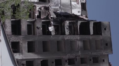 This stock vertical video shows the aftermath of the war in Ukraine - a destroyed residential building in Borodyanka, grey, flat video