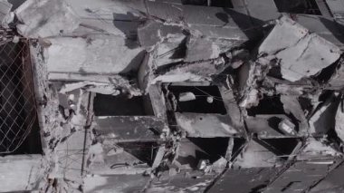 This stock vertical video shows the aftermath of the war in Ukraine - a destroyed residential building in Borodyanka, grey, flat video