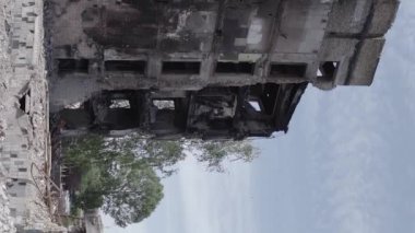 This stock vertical video shows the aftermath of the war in Ukraine - a destroyed residential building in Borodyanka, grey, flat video