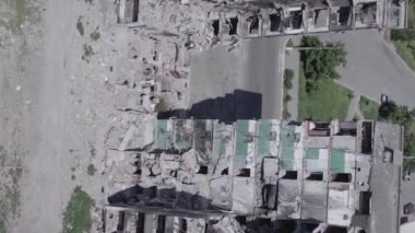 This stock vertical video shows the aftermath of the war in Ukraine - a destroyed residential building in Borodyanka, grey, flat video