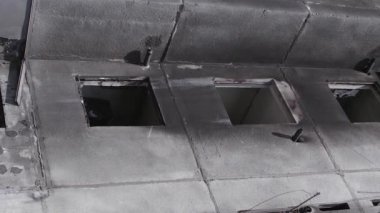 This stock vertical video shows the aftermath of the war in Ukraine - a destroyed residential building in Borodyanka, grey, flat video