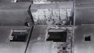This stock vertical video shows the aftermath of the war in Ukraine - a destroyed residential building in Borodyanka, grey, flat video