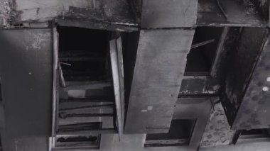 This stock vertical video shows the aftermath of the war in Ukraine - a destroyed residential building in Borodyanka, grey, flat video
