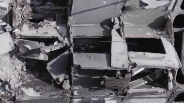 This stock vertical video shows the aftermath of the war in Ukraine - a destroyed residential building in Borodyanka, grey, flat video