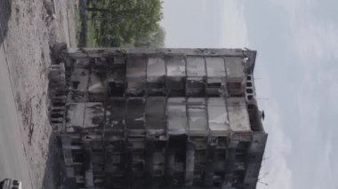 This stock vertical video shows the aftermath of the war in Ukraine - a destroyed residential building in Borodyanka, grey, flat video