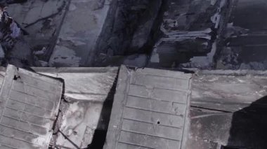 This stock vertical video shows the aftermath of the war in Ukraine - a destroyed residential building in Borodyanka, grey, flat video