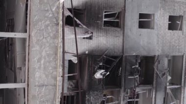 This stock vertical video shows the aftermath of the war in Ukraine - a destroyed residential building in Borodyanka, grey, flat video