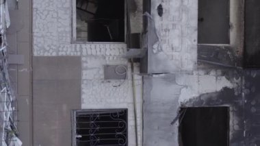 This stock vertical video shows the aftermath of the war in Ukraine - a destroyed residential building in Borodyanka, grey, flat video