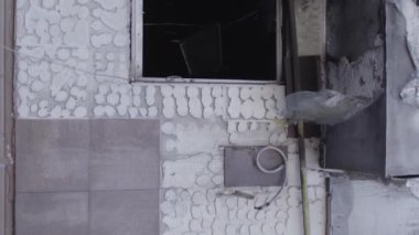 This stock vertical video shows the aftermath of the war in Ukraine - a destroyed residential building in Borodyanka, grey, flat video