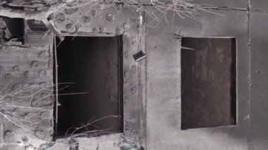 This stock vertical video shows the aftermath of the war in Ukraine - a destroyed residential building in Borodyanka, grey, flat video
