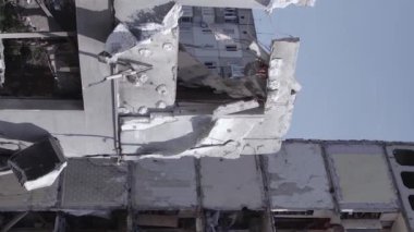 This stock vertical video shows the aftermath of the war in Ukraine - a destroyed residential building in Borodyanka, grey, flat video