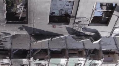 This stock vertical video shows the aftermath of the war in Ukraine - a destroyed residential building in Borodyanka, grey, flat video