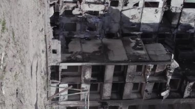 This stock vertical video shows the aftermath of the war in Ukraine - a destroyed residential building in Borodyanka, grey, flat video