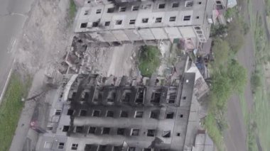 This stock vertical video shows the aftermath of the war in Ukraine - a destroyed residential building in Borodyanka, grey, flat video