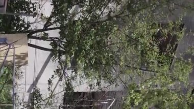 This stock vertical video shows the aftermath of the war in Ukraine - a destroyed residential building in Borodyanka, grey, flat video