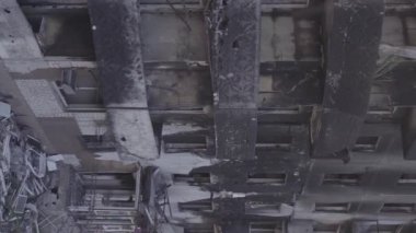 This stock vertical video shows the aftermath of the war in Ukraine - a destroyed residential building in Borodyanka, grey, flat video
